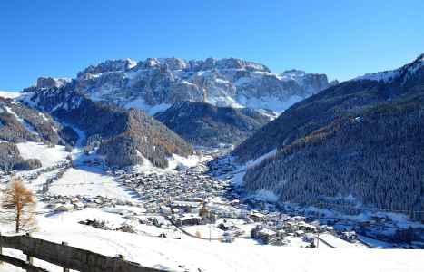 Snow-covered Selva di Val Gardena at the foot of the Sella group
